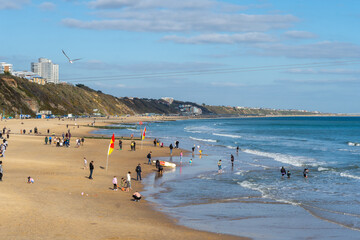 Obraz premium Bournemouth, UK - April 2nd 2023: People on Bournemouth East Beach.