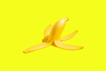 Peel of a ripe yellow banana on a yellow background