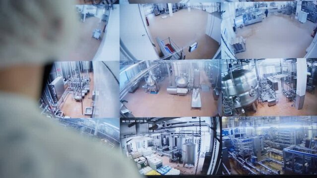 An Operator Monitors Security Camera Footages On The Split Screen Monitor In Real Time. Controlling Proper Functioning Of Workshop Production Line. Dairy Products Manufacturing. Modern Factory.