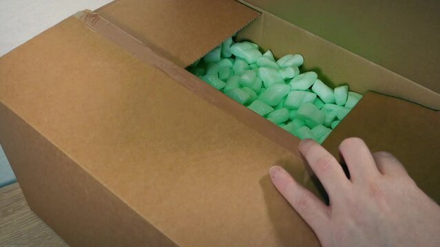 Man Cuts Open Box And Takes Out Generic Product
