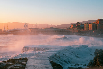 Powerful wawes on the coast of Italian city Genova. Dramatic stormy sea at the sunset. © Alican