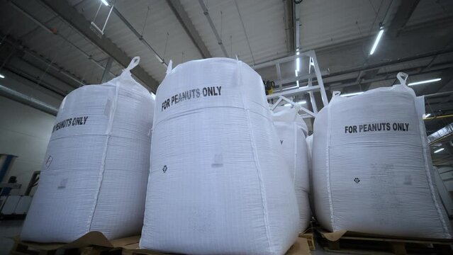 Large bags of peanuts at a large peanut processing factory