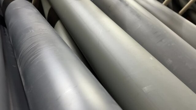 Plastic sewer pipes stacked in a hardware or plumbing store