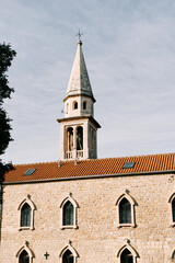 Fototapeta na wymiar High bell tower of the Church of St. John in Budva. Montenegro
