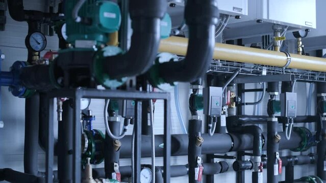 Modern industrial gas boiler room equipped for heating process. Heating gas boilers, pipelines, valves.