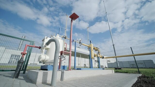 Gas distribution station. Industrial facility. Gas processing station with pipes on a summer day in an open space. Gas supply. Transportation of natural gas through pipes.