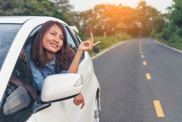 Happy asian women drive new car. Women Hand give remote control car key to man rental car service. Close up hands young woman showing new car key. Women driver giving car rental service smiling face