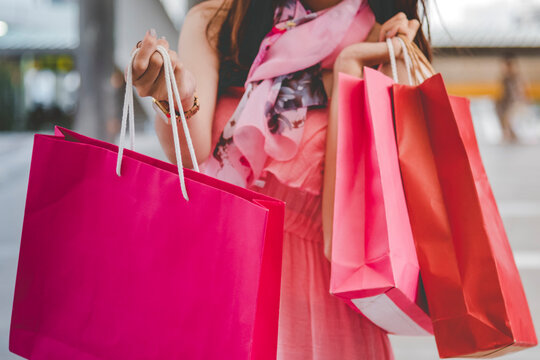 Shopaholic Women holding shopping bags ,money ,credit card person at shopping malls.Fashionable Woman love online website with sales tag on black Friday. E-commerce fashion digital marketing lifestyle