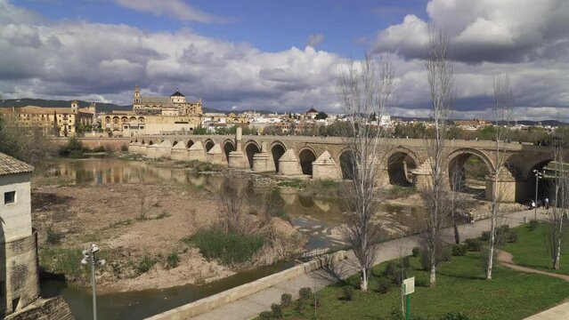 Captivating footage of the Roman Bridge, an ancient stone bridge spanning the Guadalquivir River in old town Cordoba, Andalusia region, south Spain