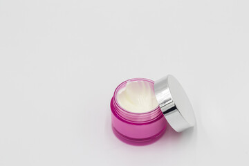 cream skincare product  makeup mask in pink jar on white background .