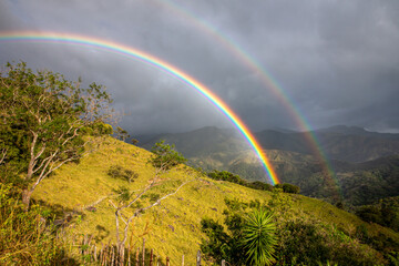 Double Rainbow over Lush Green Mountains - 684404655