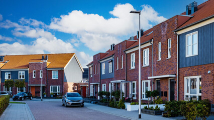 Dutch Suburban area with modern family houses, street with modern family homes in the Netherlands - obrazy, fototapety, plakaty