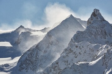 Fototapeta na wymiar Winter high mountains in clouds, snowing