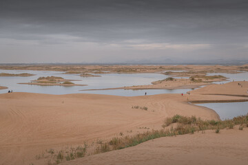 Fototapeta na wymiar The river going through the desert in Wuhai, Inner Mongolia, China