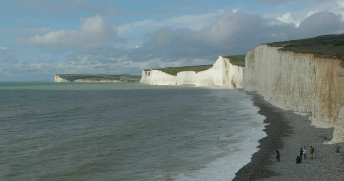 Clouds, waves, sea, beach, people, chalk cliffs Seven Sisters, Birling Gap near Eastbourne, East Sussex, England, Great Britain
