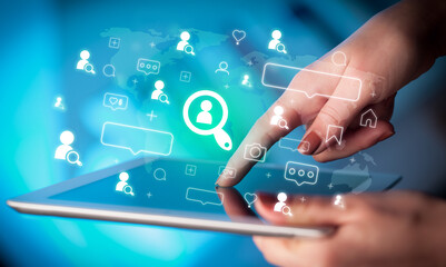 Close-up of a hand using tablet, social media concept