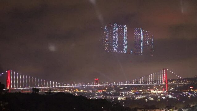 Turkey is celebrating its 100 year anniversary and 2023 drones are writing 100. Yil (100 Years), over the bosphorus bridge in Istanbul, Turkey.
