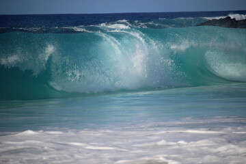 aquamarine waves crashing on the shoreline