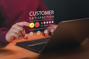 Customer use a laptop give angry emotion face on virtual screen for feedback review satisfaction service opinion and testimonial on application. Online customer review satisfaction feedback survey.