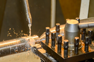 The lathe machine finish cut  metal shaft parts with liquid coolant method.