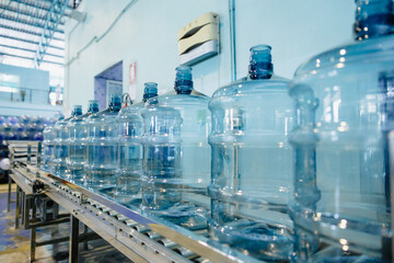 Plastic PET drinking water gallon bottle clean in conveyor production line in drink water plant...