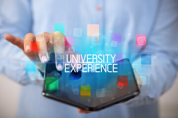 Young man holding a foldable smartphone