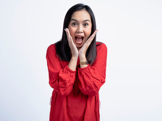 A portrait of a happy Asian woman wearing a red shirt, posing joyfully with open hands near her face. Isolated against a white background.