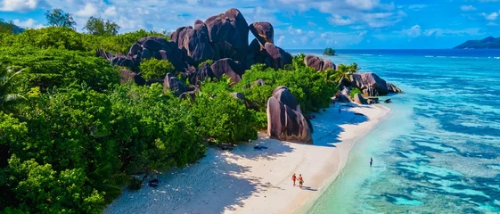 Washable wall murals Anse Source D'Agent, La Digue Island, Seychelles Anse Source d'Argent, La Digue Seychelles, young couple men and woman on a tropical beach during a luxury vacation in the Seychelles. Tropical beach Anse Source d'Argent, La Digue Seychelles