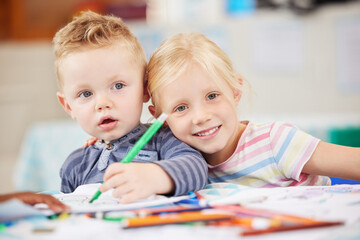 Face, kid or friend with drawing in classroom for learning, education and development of motor skills. Little girl, boy or student with smile for art project, homework or assessment in kindergarten