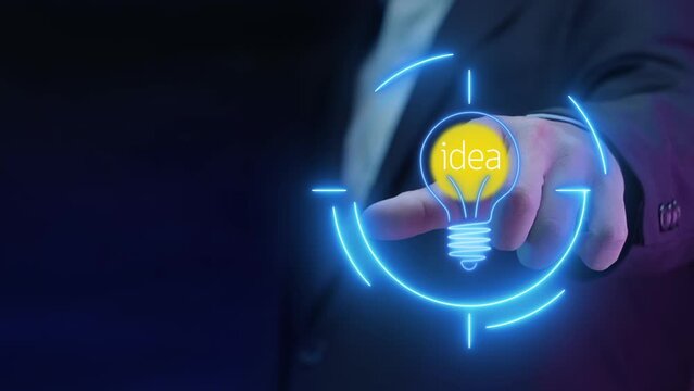 Business man is pointing finger, showing shining lightbulb with idea word that in neon circle. Innovation and idea concept.
