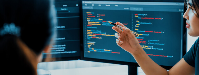 Young Professional website developer and cooperative computer engineer team brainstorming and sharing idea of program writing and coding at modern meeting room. Teamwork concept. Closeup. Burgeoning.