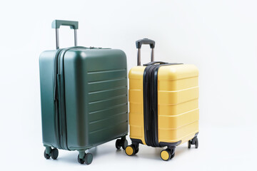 Yellow and green suitcase on white background close-up, travel concept.