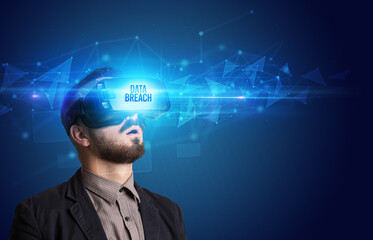 Businessman looking through Virtual Reality glasses, virtual security concept