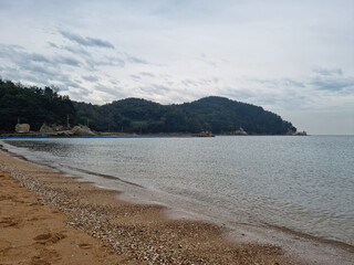 It is a beach with a mountain view.