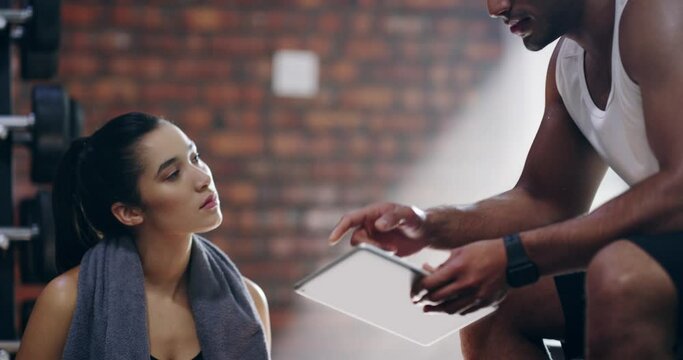 Gym, tablet and woman consulting personal trainer for fitness, goals or planning workout schedule. Digital, training app and female athlete with coach for online, sign up or sports center membership