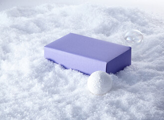 a purple gift box on the snow