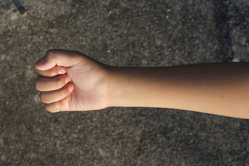 A child's hand clenched into a fist.