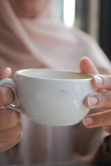 women holding a coffee cup 