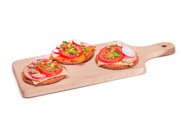 Crispy Cracker Sandwiches with Tomato, Sausage, Cheese, Green Onions and Radish on Cutting Board -...