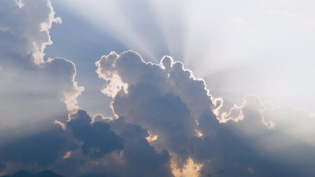 Sun blocked by cloud and emitting rays beyond clouds from corner feels like hope and godly or natural vibe