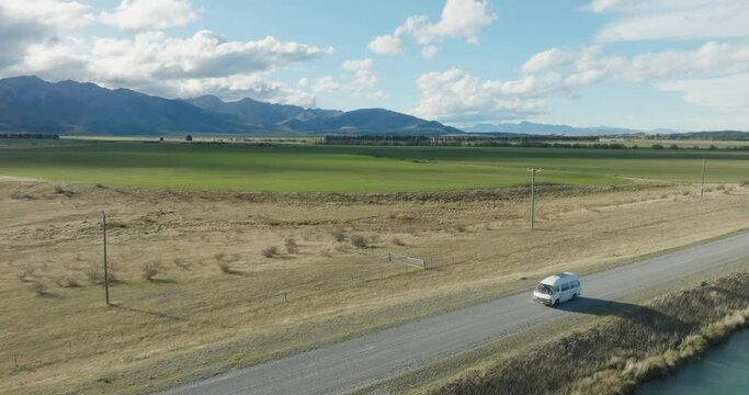 Aerial landscape view of campervan road trip through rural countryside of Mackenzie District and Pelennor Fields shooting location from Lord of the Rings, South Island in New Zealand Aotearoa