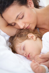 Obraz na płótnie Canvas Mom, baby and kid sleeping on bed together for calm break, peace or dreaming to relax at home. Face of tired mother, young child and cozy nap for newborn development, healthy childhood growth or rest