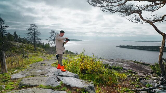 Tourist With Camera Standing At Top Of Mount In Beautiful Natural Location, Man Taking Pictures