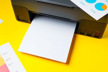 Modern printer with paper on yellow background