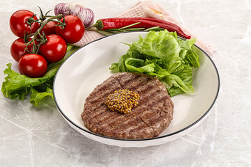 Frilled beef burger cutlet with iceberg
