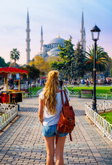 Young tourist woman walking to famous blue mosque, Sultanahmet in Istanbul- Turkey