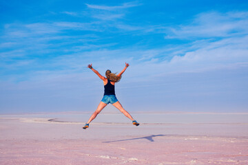 Happy woman jumping on salt beach- Golu tuz, Turkey