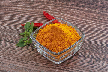 Yellow vibrant curcuma powder in the bowl