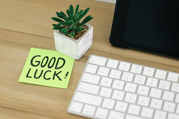 Good Luck text written on sticky notes on a work desk