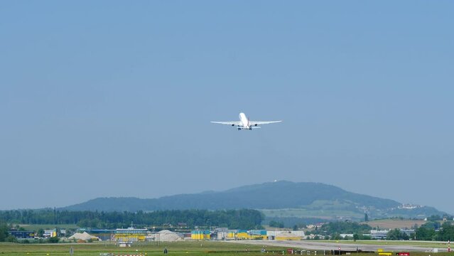 Rear Of Airbus A330 Taking Off From Zurich Airport In Switzerland. wide shot